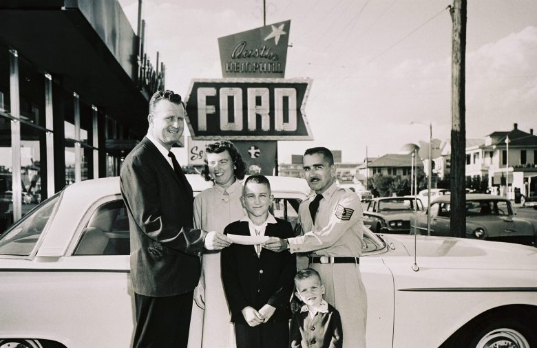 Red McCombs with customers at Hemphill Ford in 1958.