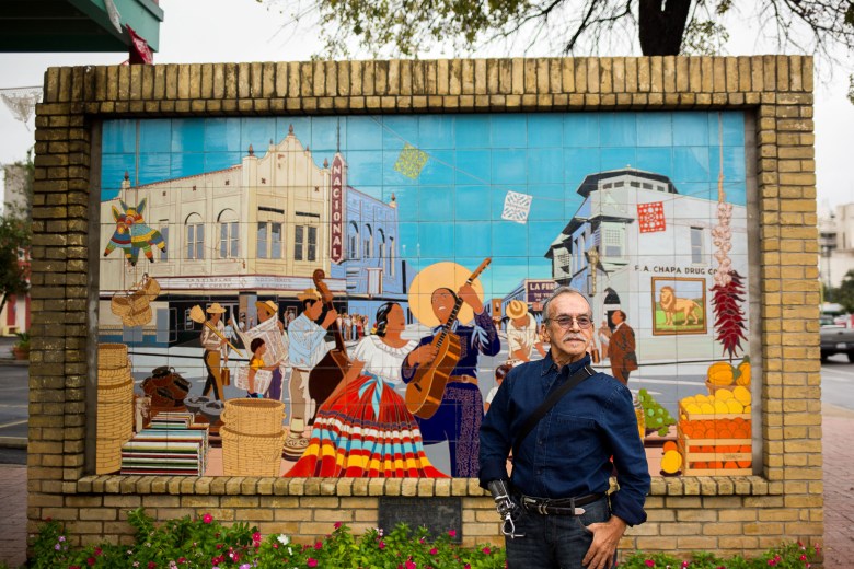 Artist Jesse Treviño poses for a portrait in front of his mural La Feria which was installed in 1983.