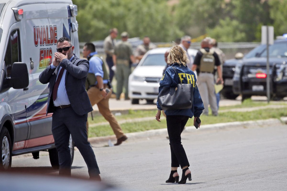 Law enforcement personnel, including the FBI, gather near Robb Elementary School following a shooting, Tuesday, in Uvalde, Texas.