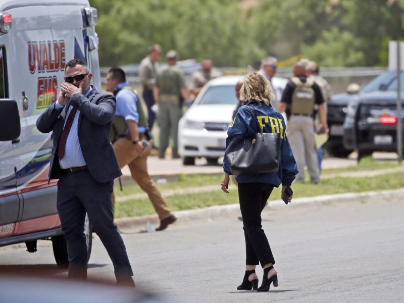 Law enforcement personnel, including the FBI, gather near Robb Elementary School following a shooting, Tuesday, in Uvalde, Texas.