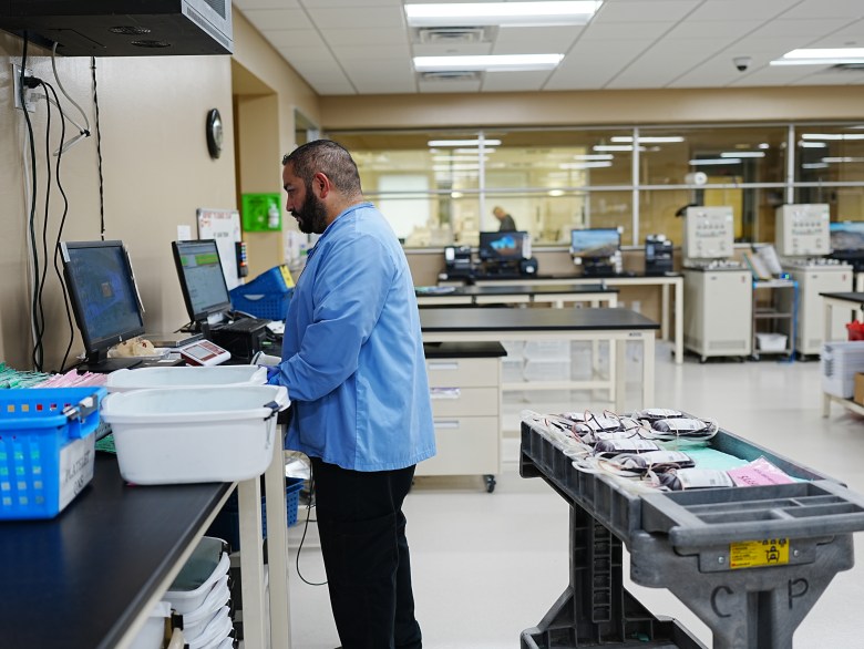 Rudy Rodriguez, supervisor at South Texas Blood and Tissue, prepares bags of full blood from a donation drive to be processed.