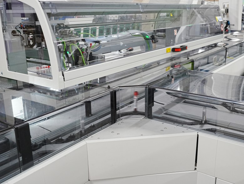 Test tubes carrying blood samples travel along the track in the testing lab at QualTex Laboratories.