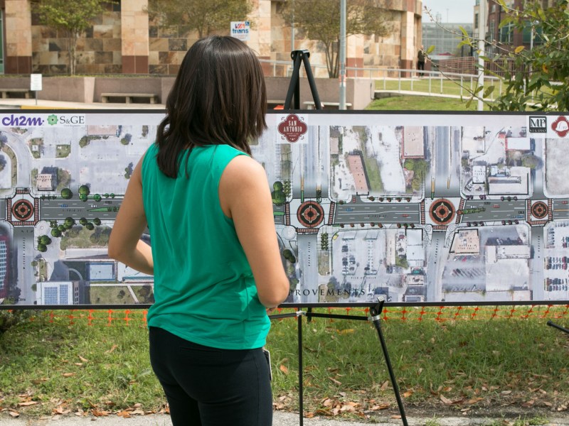 Senior Public Information Officer for Transportation and Capital Improvement Flor Salas sets up the visual display at the groundbreaking of the 2012 bond project for Frio Street.