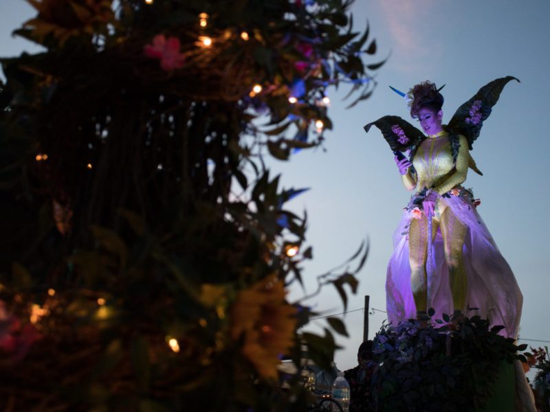 Silhouettes are lit up at dusk on the BabiO's float before the parade begins.