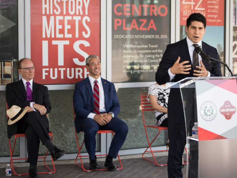 (From left) Bexar County Judge Nelson Wolff and Mayor Ron Nirenberg listen as outgoing Councilman Rey Saldaña (D4) formally accepts the role of VIA Chair.