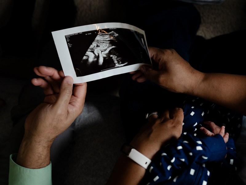 Damara Hamlin-Vaughn and Chris Vaughn hold an ultrasound of their baby Jediah, who was conceived through IVF.