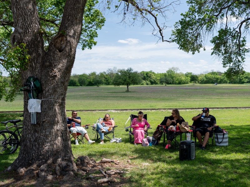 The Valdez family sits at their Brackenridge Park campsite on March 29, 2024.