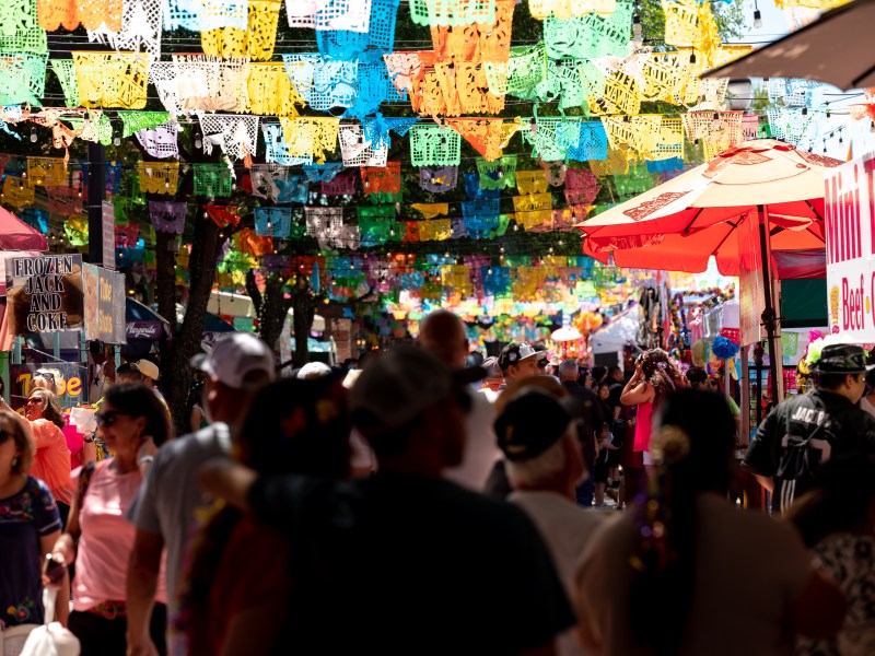 Crowds of Fiesta-goers fill up the alleyways in Market Square despite the news of a shooting the night before.