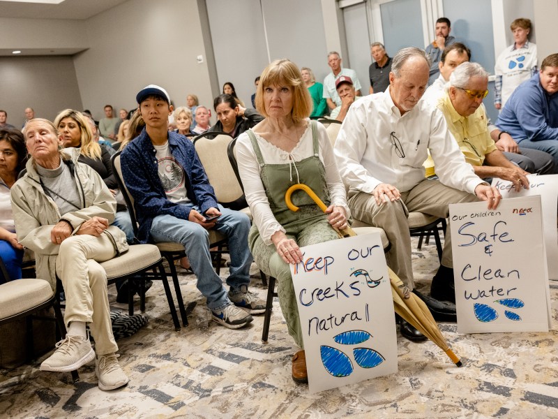 Community members opposing a proposed wastewater treatment plant attend a TCEQ public hearing on Tuesday evening.