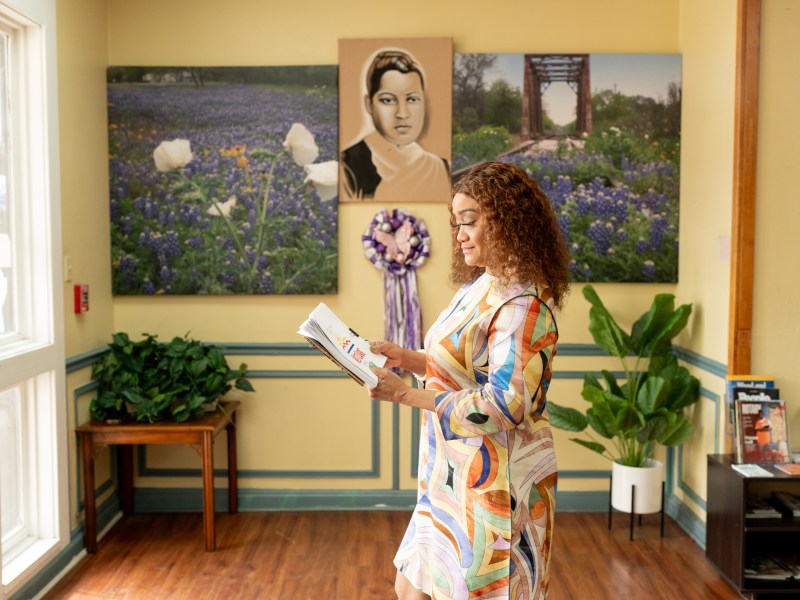 Dr. Keely Petty walks by a portrait of Ella Austin at the Ella Austin Community Center.