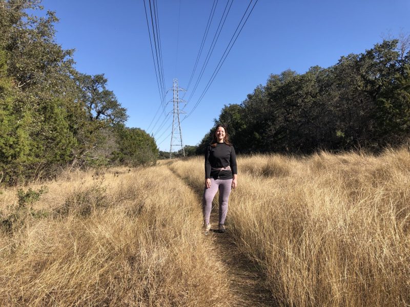 Jessica Mrozinski stops along a powerline right-of-way that's part of Century Tree Loop.