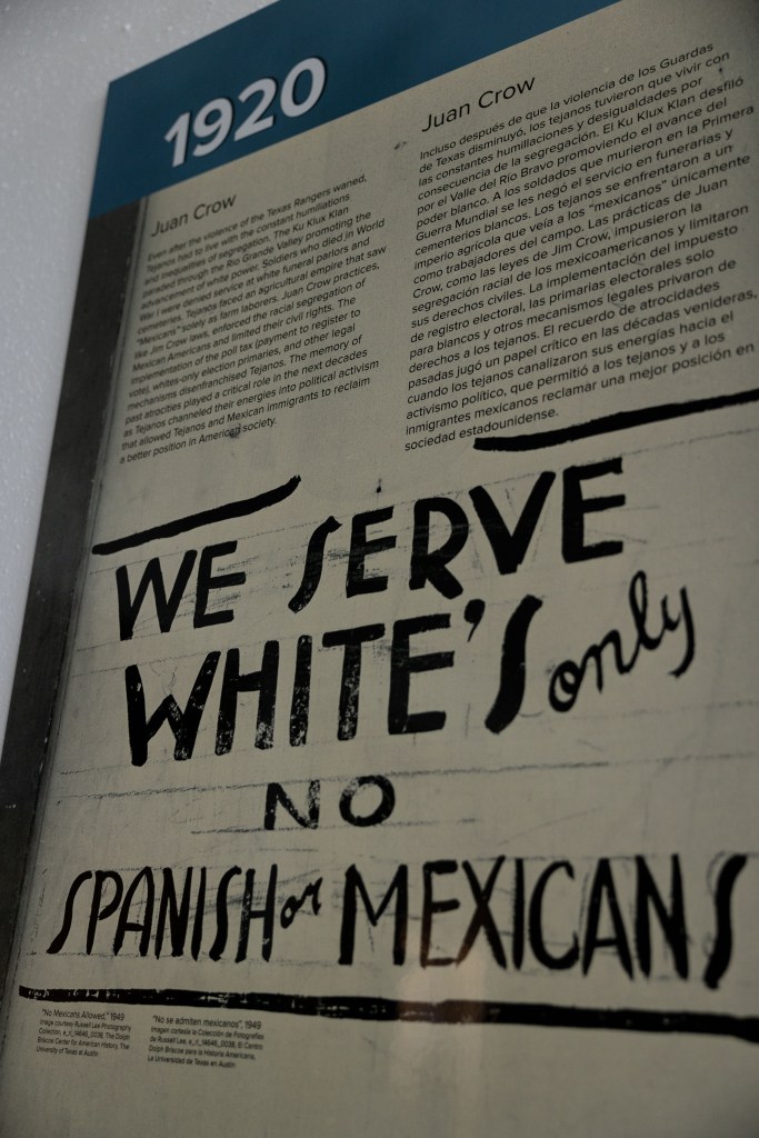 Panels explaining borderland history lines the walls inside of the Guadalupe Bookstore as part of the Life and Death on the Border 1910-1920 traveling exhibit created by Refusing to Forget.