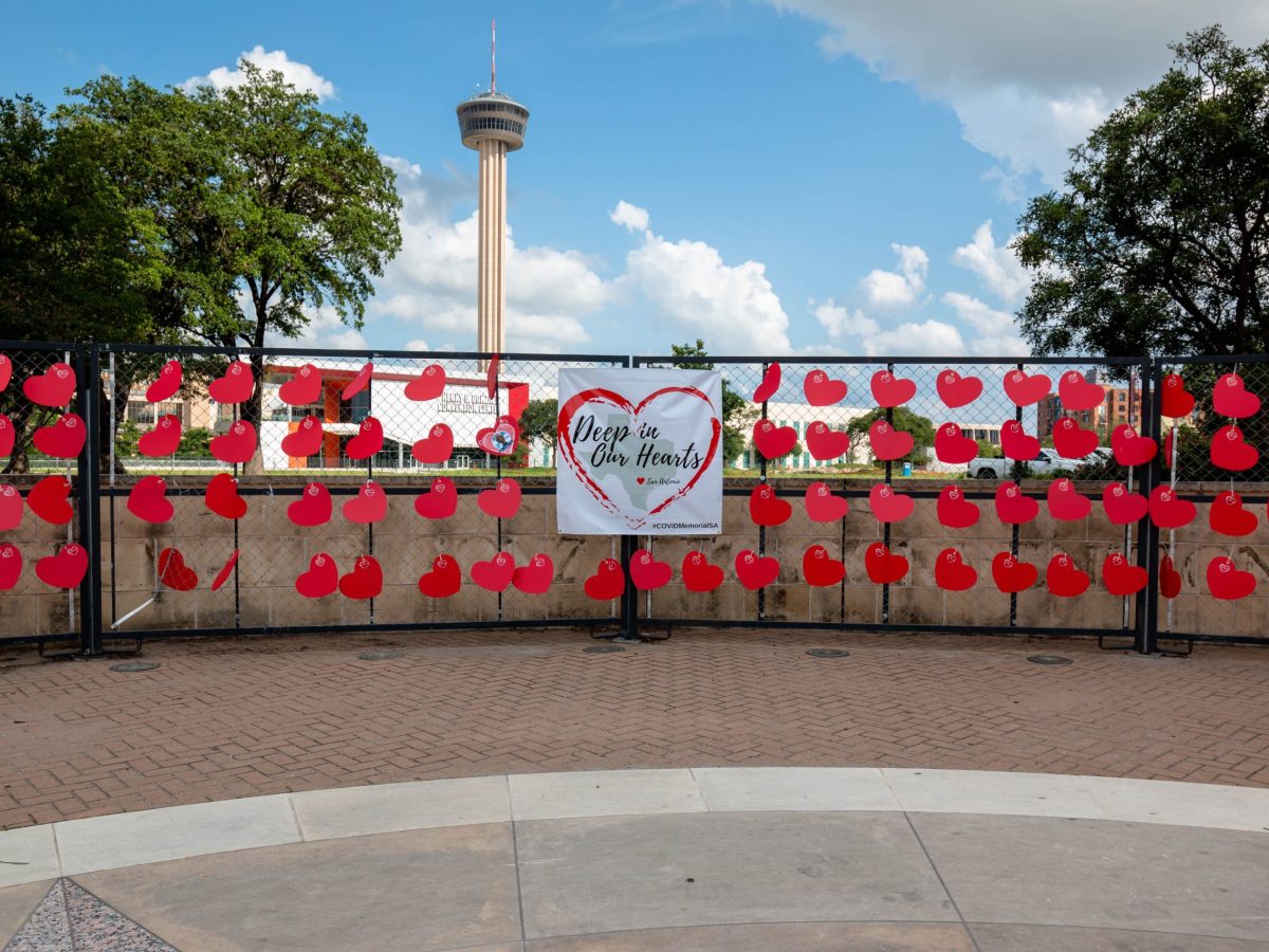 The Tower of the Americas stands tall in the distance as a memorial honors the nearly 3,500 lives lost to COVID-19 during the pandemic.