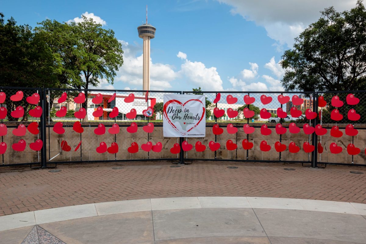 The Tower of the Americas stands tall in the distance as a memorial honors the nearly 3,500 lives lost to COVID-19 during the pandemic.