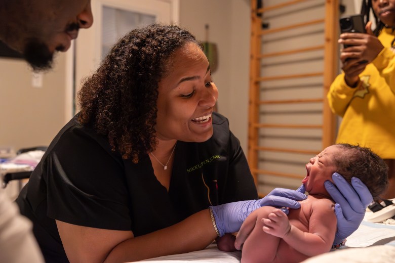 Certified nurse midwife Nikki McIver-Brown performs a wellness check on Genise Head's newborn son. She takes his weight and measurements and takes note of his development.