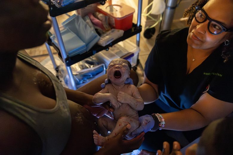 Certified nurse midwife Nikki McIver-Brown hands Genise Head her baby boy immediately after delivery so she can start bonding with her son skin to skin.