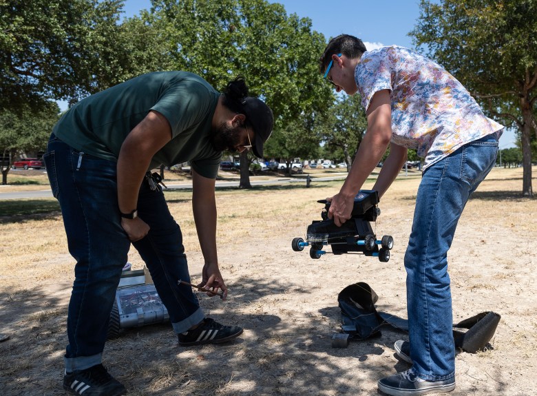 Astroport Mechanical Engineer Milton Cordova (left) works with summer intern Frank Lucci, 15, to test a prototype for a NASA project Tuesday.