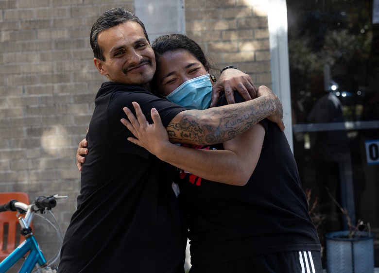 Isaac Mercado hugs Madelein Santibañez, director of harm reduction at Corazón Ministries Monday before he leaves to go to his first job since 1989. Mercado was born addicted to heroin and battled a severe addiction for more than four decades, before seeking recovery six months ago. He shares that his life was saved by someone who administered Narcan to him when he was overdosing.