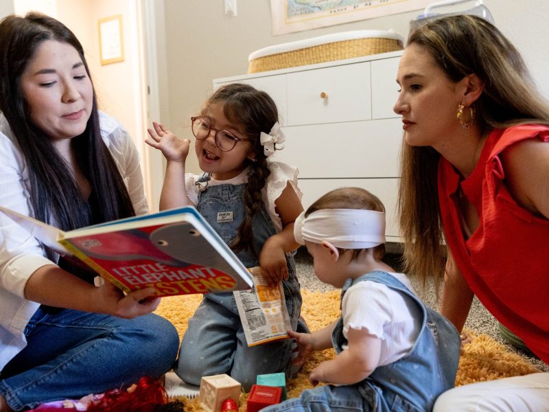 Mothers Madison O'Brien (right) and Krystal O’Brien read with their daughters, Amelia, 4, and Eloise, 11 months Wednesday. Madison O’Brien’s adopted sibling is disabled so she wanted her children to learn alongside students of varying abilities.