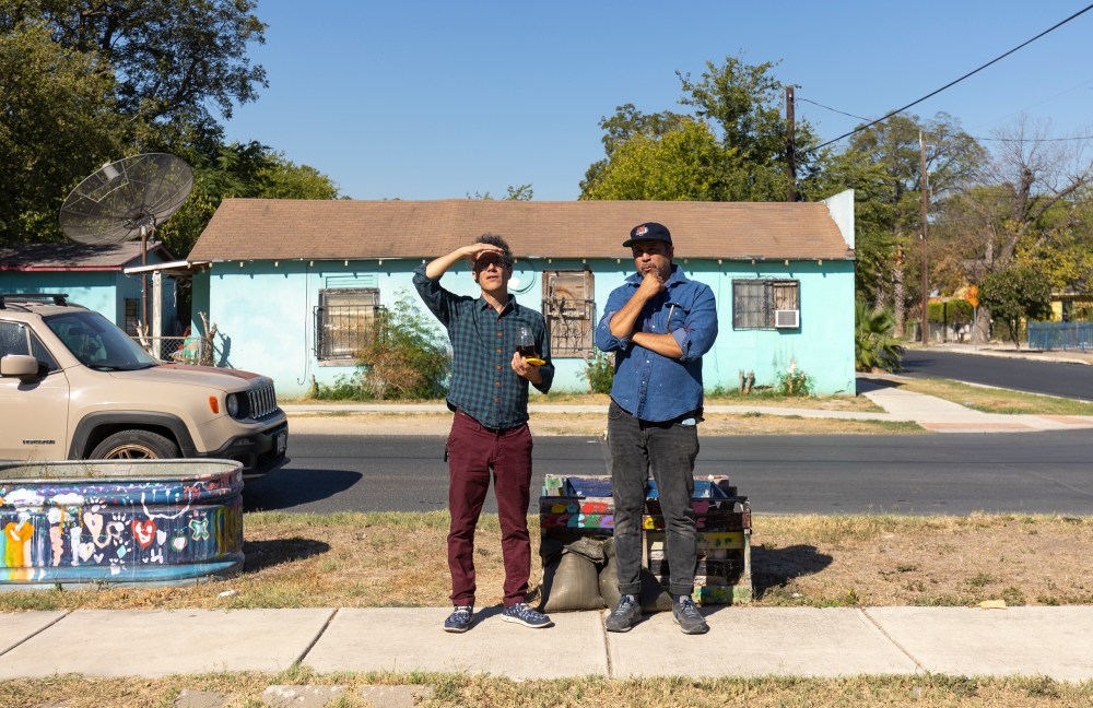 Artist Cruz Ortiz (right) and San Antonio Report Art and Culture reporter Nicholas Frank (left) discuss one of the murals painted on the side of the San Anto Cultural Arts building Wednesday.