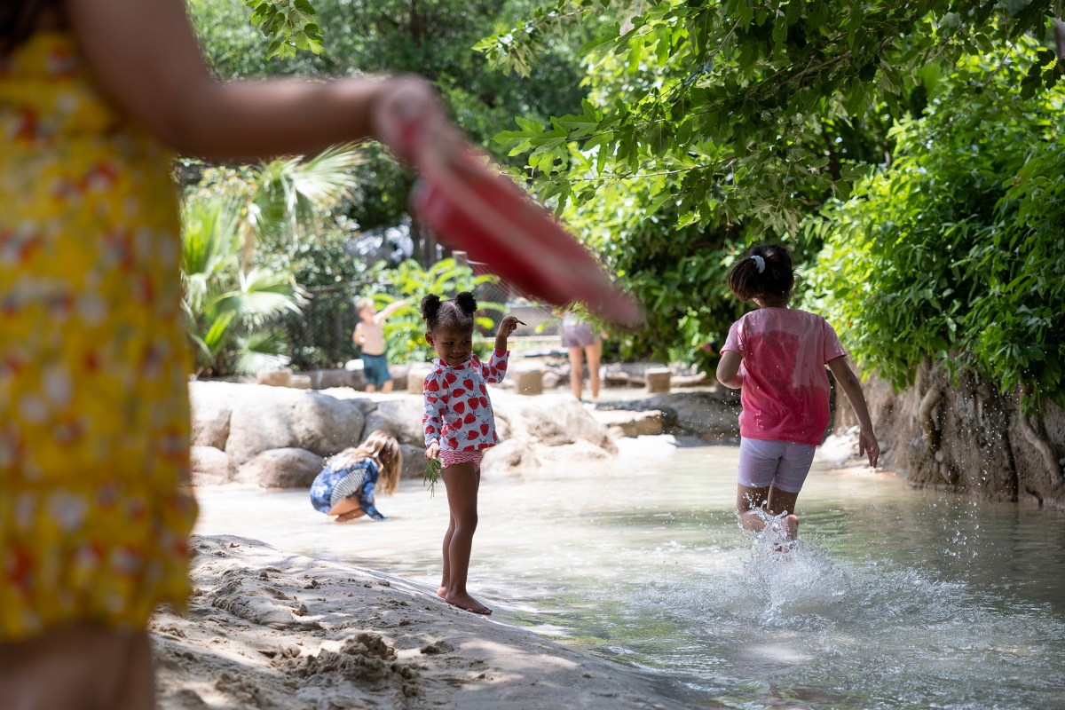 Kids cool off at the San Antonio Zoo on a hot day.