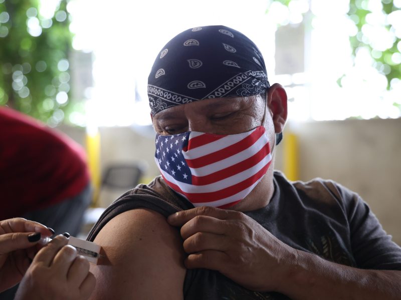 Federico Perez receives the first dose of the Pfizer vaccine provided by Metro Health during a vaccine clinic at the Zoo Wednesday.