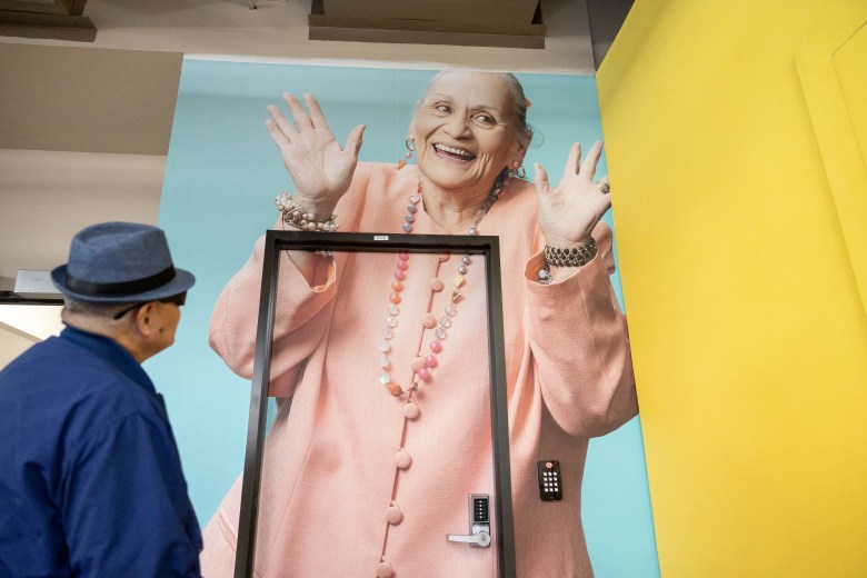 Freddie Flores enjoys a large portrait of his wife on one of the walls near his work bench. They met while working at Vibrant Works.