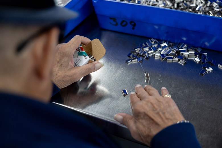 Freddie Flores, who lives with a vision impairment, packages clam clips refills at Vibrant Works Thursday.