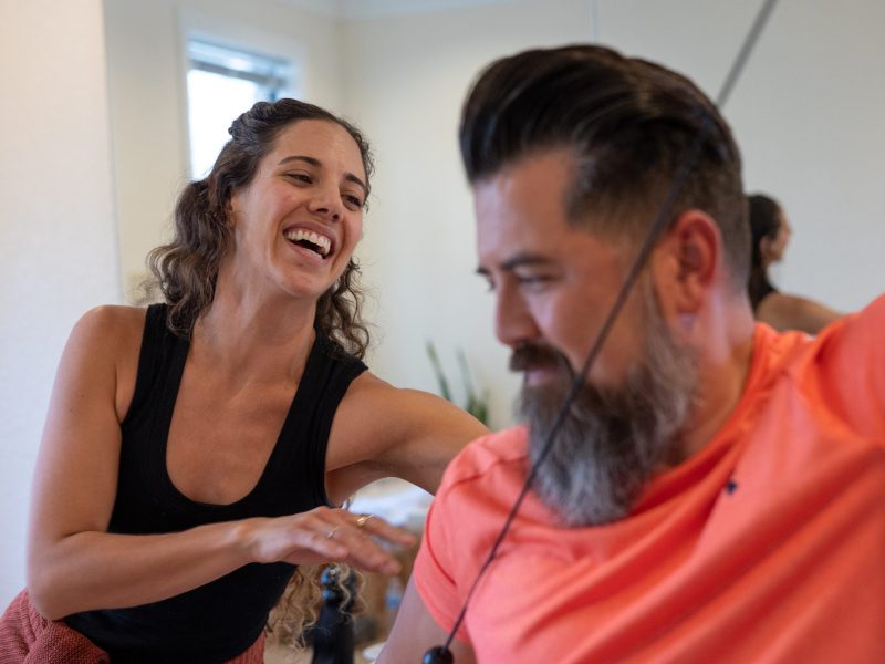 Kaylie Caires, founder and owner of Kind Body Works, leads client Chris Scott through a series of Gyrotonic exercises Monday.