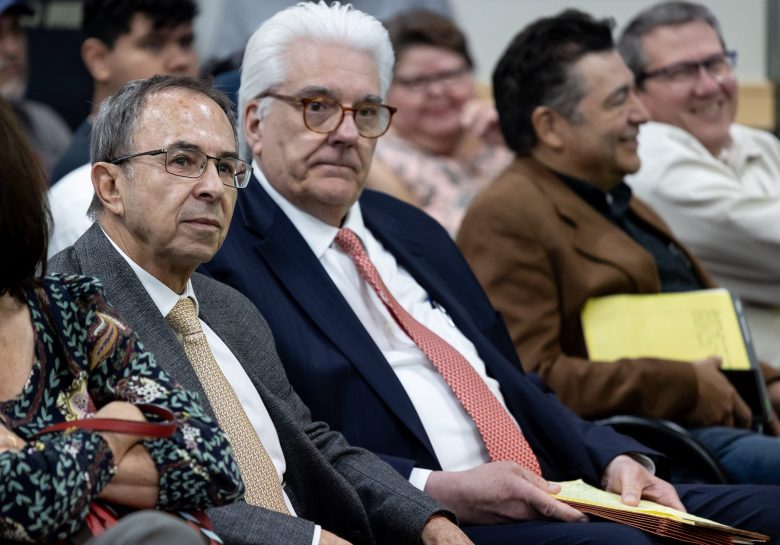 Fermin Rajunov (left) sits next to his attorney David Prichard at a Zoning Commission meeting Tuesday.