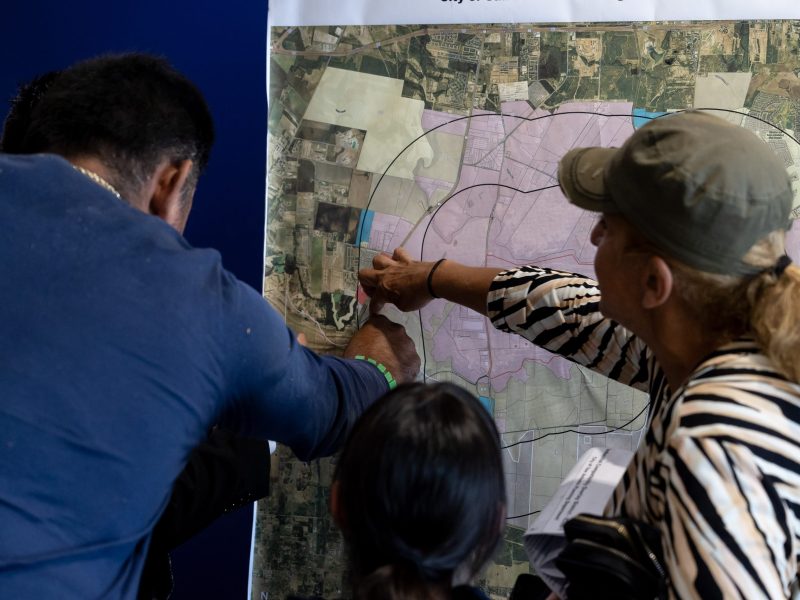 Zenon Solis, with the City’s Planning Department, helps Aleida Montellano and her family understand that since their home is in Bexar County, they will not be impacted by the proposed industrial zoning overlay within two miles of Toyota plant.