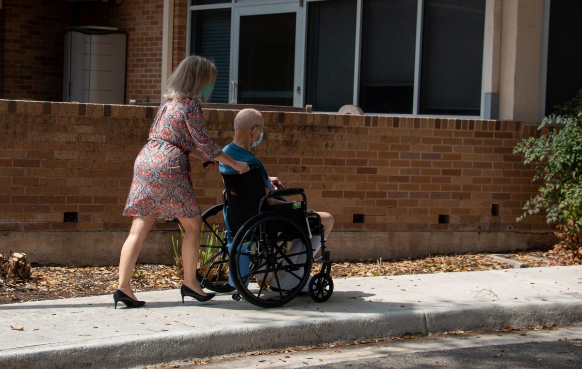 Sandy Cilone escorts her 95-year-old dad into the Morningside Manor Assisted Living facility. Both donned in masks, Sandy is the only visitor allowed in with her father. Tuesday, March 16, 2021.