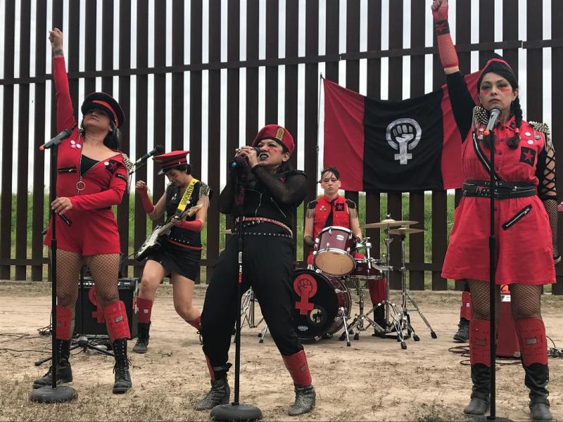 Amalia Ortiz (center) performs Canción Cannibal Cabaret at the U.S.-Mexico border.