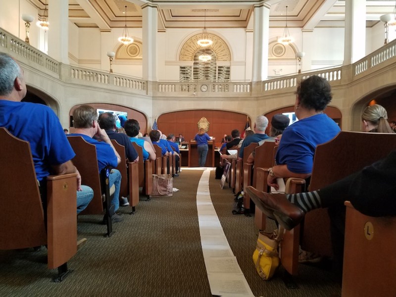 Residents that live near I-10 West collected thousands of signature and rolled them out onto the floor in City Council chambers. Photo by Iris Dimmick.