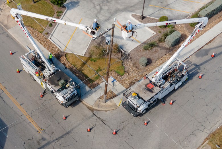 CPS Energy linemen work on a power line on the West Side on Sunday.