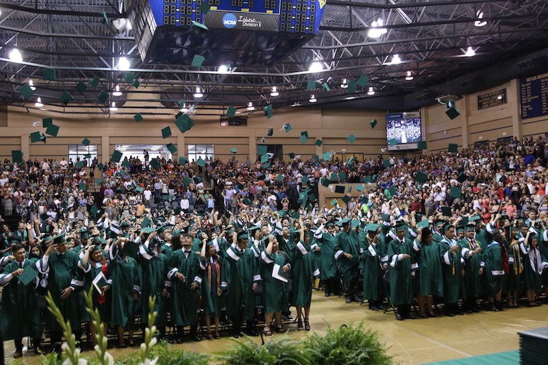 Students of Kennedy High School's Class of 2016 throw their caps into the air after their graduation ceremony. Photo courtesy of Edgewood ISD.