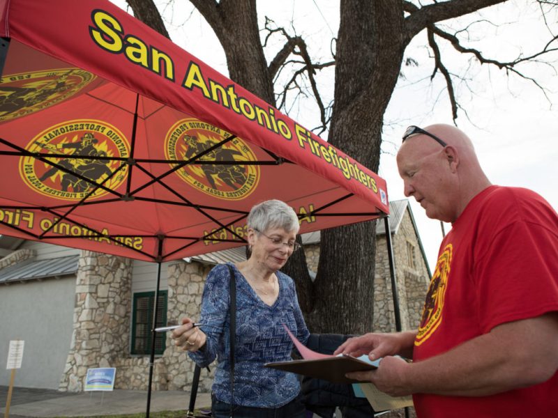 Robin Black (left) speaks with retired fire department Lt. Bert Kuykendall about charters petitions in February 2018.