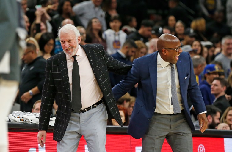 Head coach of the San Antonio Spurs Gregg Popovich greets assistant coach of the Golden State Warriors Mike Brown at the end of regulation at the AT&T Center in 2019. December 31, 2019 in San Antonio, Texas.  