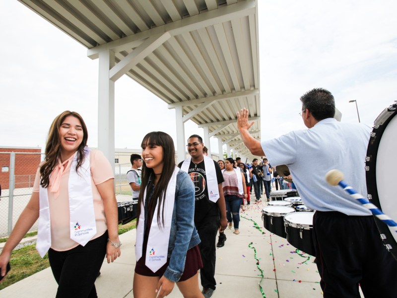 South San Antonio High School seniors, (Left) Audrey Arredondo and Samantha Magna, walk through the drum line at the Surprise Graduation Celebration.