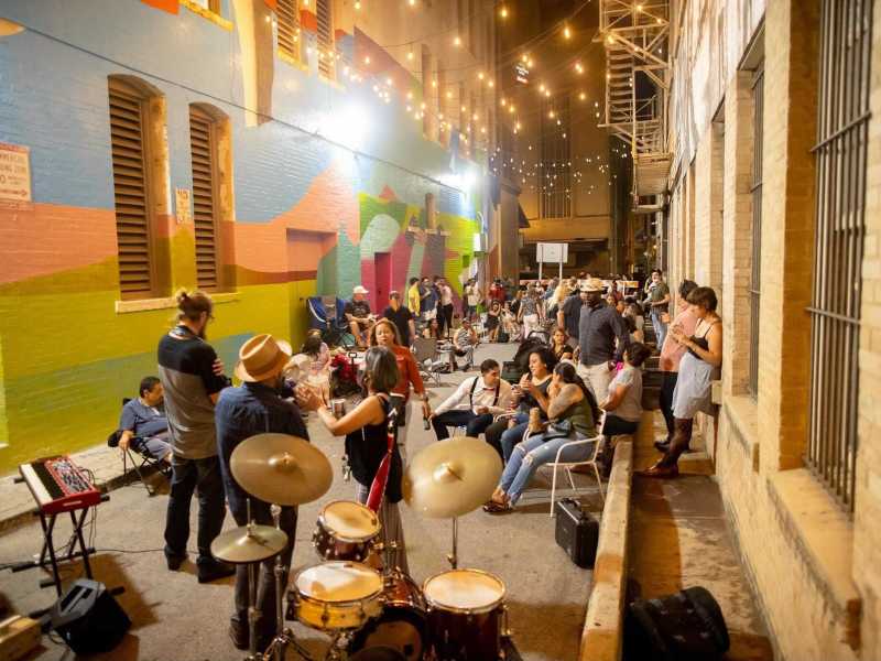 A band plays live music in Peacock Alley while the audience listens and mingles during a Friyay event hosted by Centro.