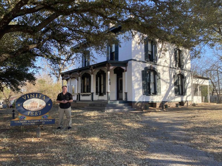 Grayson College Professor Andrew Snyder stands outside Vinita, the Munson family’s 1800s home in Denison.