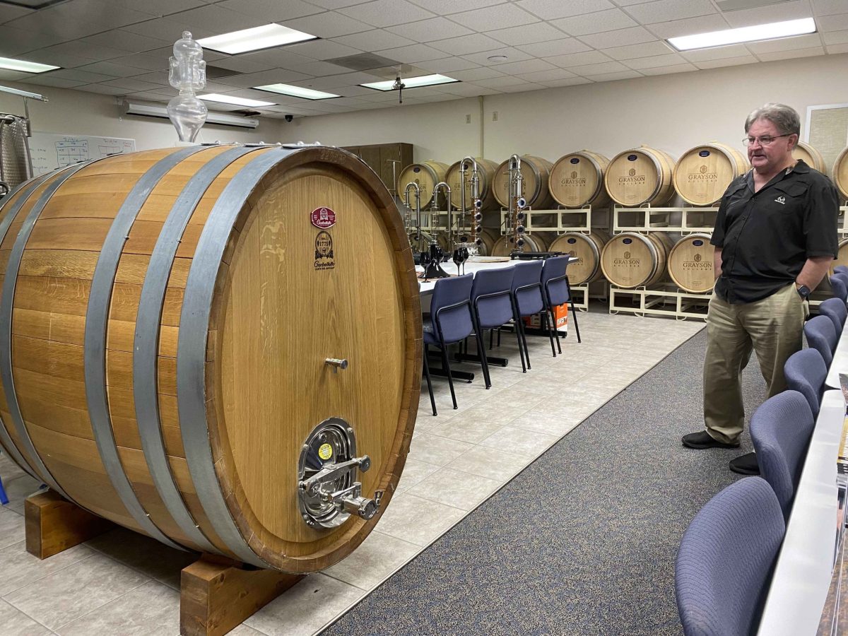 Grayson College Professor Andrew Snyder shows off a large winemaking barrel in the school’s Viticulture and Enology department, named for Denison horticulturist T. V. Munson.