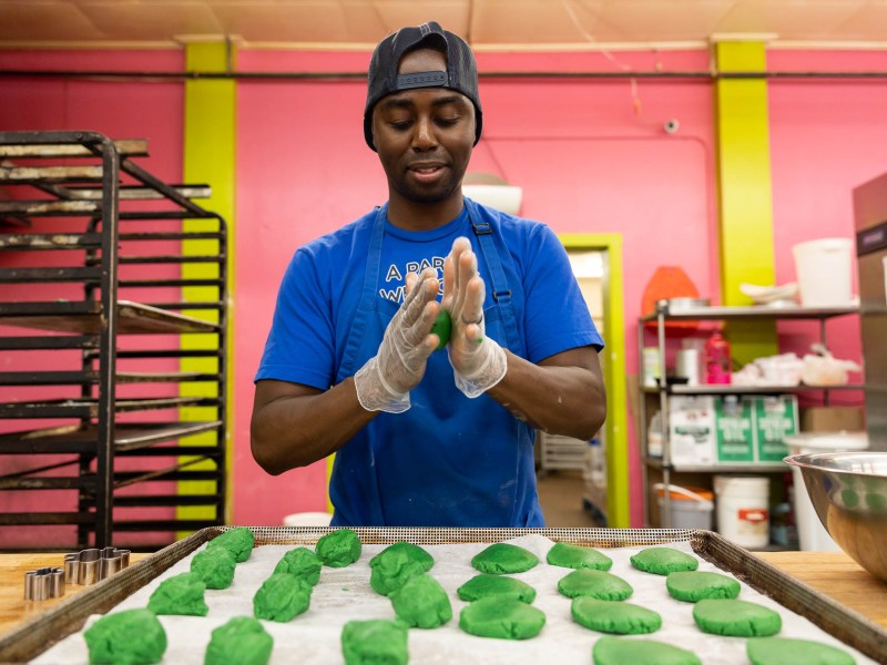 Marcus Pitts, co-owner of Southern Roots Vegan Bakery, prepares a batch of shamrock themed vegan cookies.