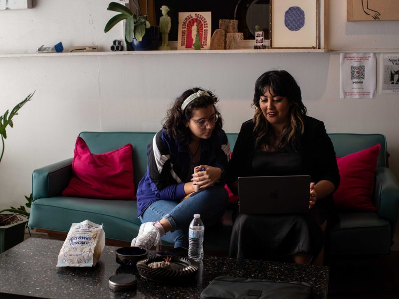 Sealia Montalvo (left) and Crisa Valaldez discuss upcoming projects and ideas at the gallery space where they’re hosting Mothering, their curated art collective on Saturday.