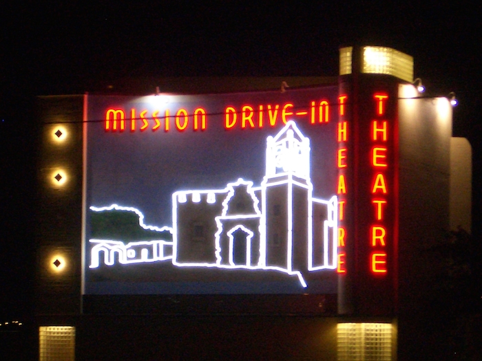 Night scene with theater mural outlined in LED lights at the Mission Marquee Plaza grand opening June 7, 2014. Photo by Lily Casura.