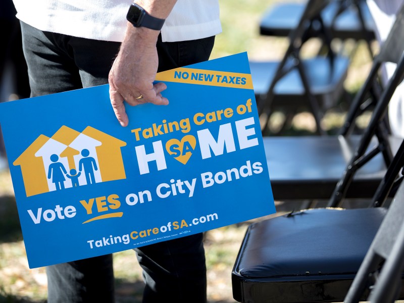 A man holds a flier supporting the 2022 municipal bonds during a bond campaign kickoff event at Woodlawn Lake Park in March.