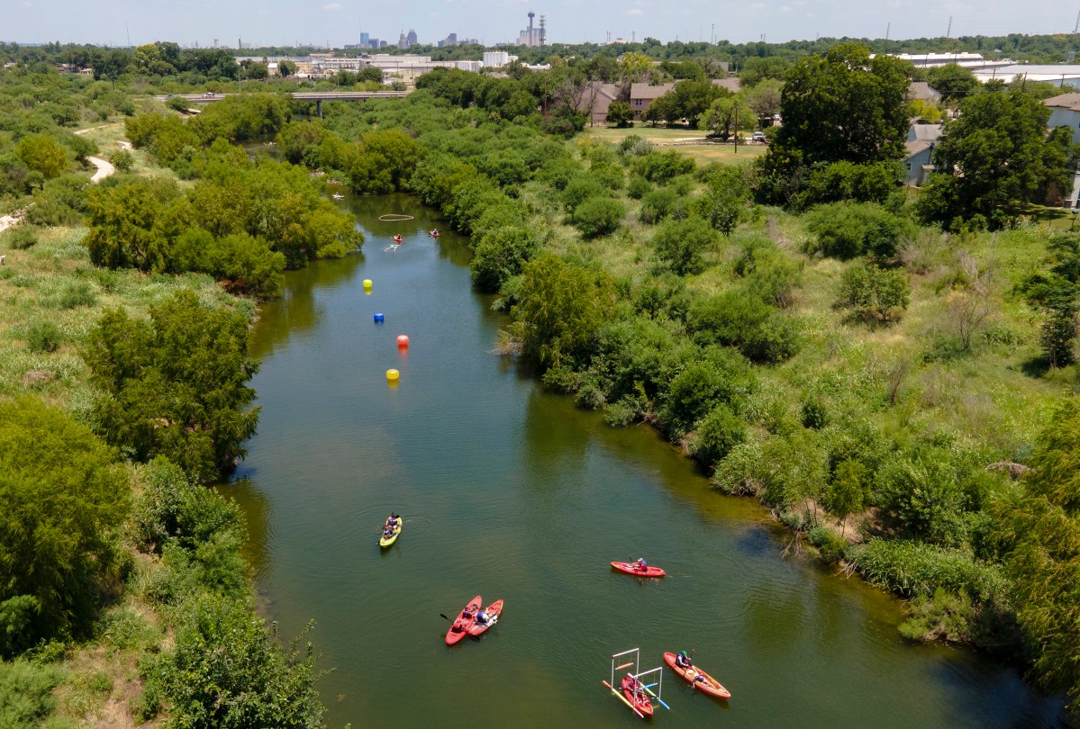 People kayak on the San Antonio River during the Mission Reach Flotilla Fiesta on Saturday.