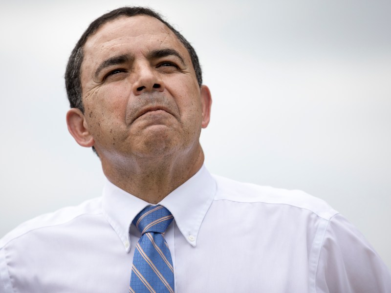 U.S. Rep. Henry Cuellar (D-Laredo) listens to a speaker at a rally downtown on Wednesday.