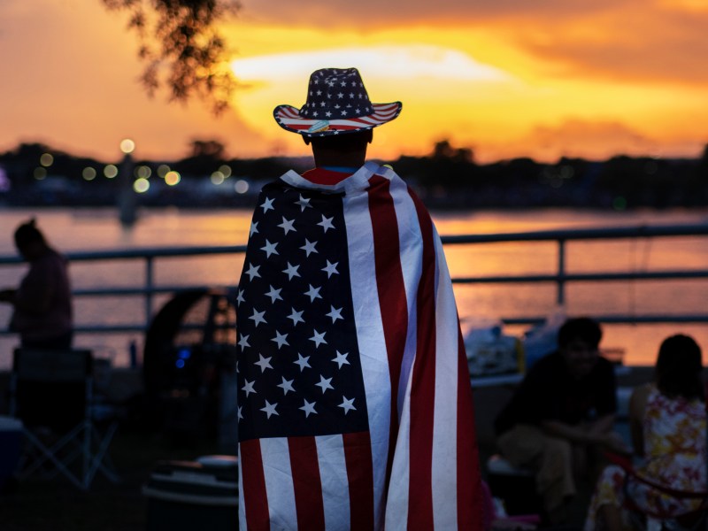 Thomas Zurita waits for the start of the fireworks display during the Fourth of July Celebration at Woodlawn Lake Park on Sunday.