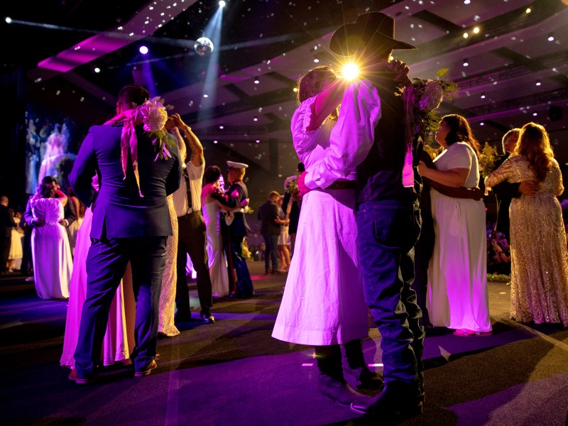 Matthew Rodriguez dances with his wife, Lucy, alongside 51 other couples during a mass wedding ceremony at Community Bible Church on Saturday.